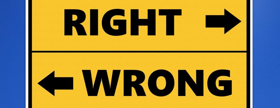 A street sign labeled "right" and "wrong" with arrows pointing in opposite directions.