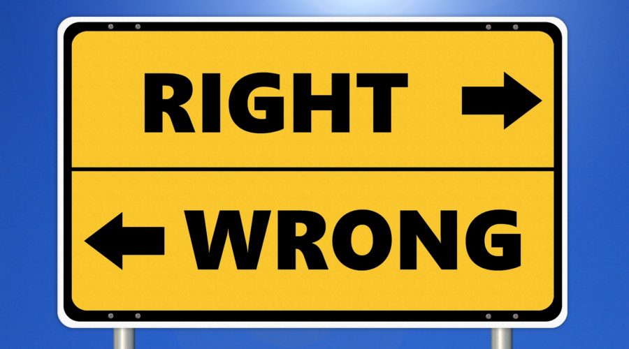 A street sign labeled "right" and "wrong" with arrows pointing in opposite directions.
