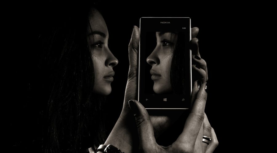 A face reflected in a smartphone